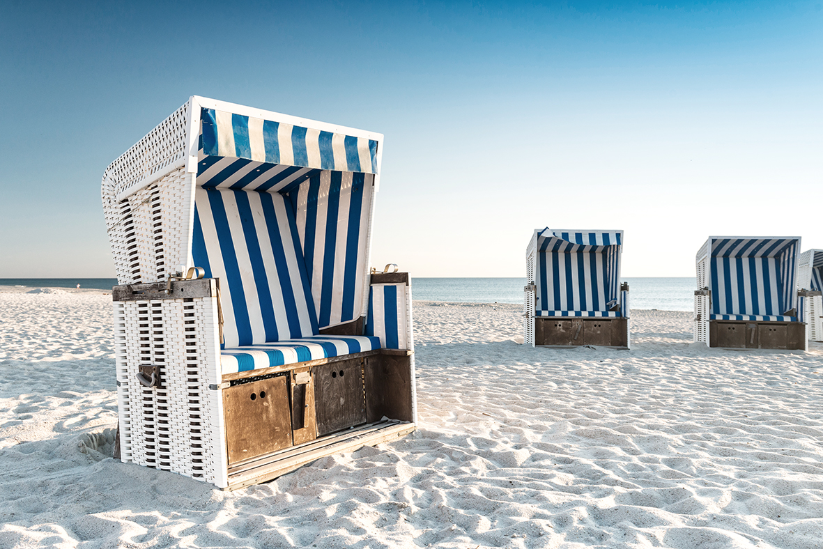 Beach – chairs on the island Sylt on sunset. Germany.